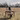 A woman sitting at a desk in a field