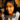 Young woman's face, looking into camera, with subtitle "I'm not real, I'm here to blackmail you."